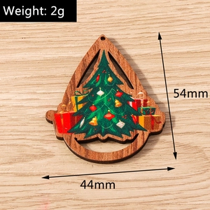 Detalle del adorno navideño de madera en forma de gota con diseño de árbol y regalos