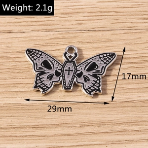Macro view of gothic butterfly pendant showing skull wings and coffin detail with dimensions