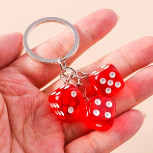 Creative translucent red acrylic dice keychain with silver metal ring held in hand