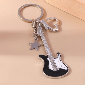 Close-up of a guitar keychain with heart clasp, star pendant, and black-white finish