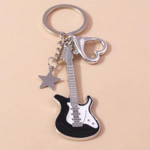 Detail of electric guitar keychain with heart carabiner and star charm in black and white