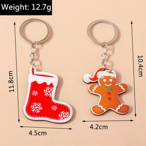 Detailed view of gingerbread man and red sock Christmas keychains with size dimensions