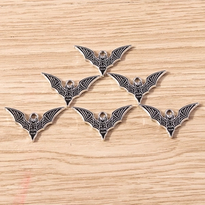 Detailed view of six vintage silver bat charms with black enamel wings for DIY jewelry