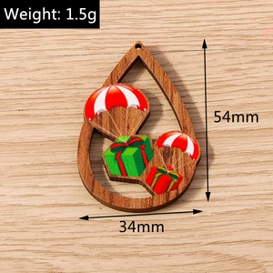 Vista detallada del colgante de madera navideño en forma de gota con motivos de regalos