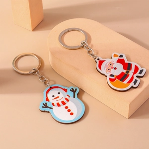 Porte-clés de Noël avec Père Noël et bonhomme de neige sur support d'affichage