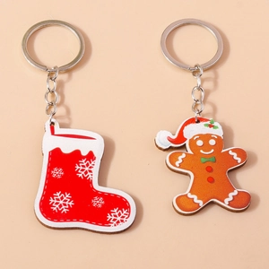 Close-up of a gingerbread man and Christmas stocking keychain set with silver rings