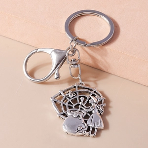 Detail of silver vintage Halloween keychain with witch, spider web and lobster clasp