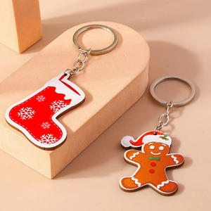 Christmas gingerbread man and red snowflake sock charms on silver metal keychains