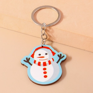 Porte-clés bonhomme de neige mignon avec cache-oreilles rouges et écharpe sur fond bleu