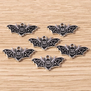 Detailed macro shot of gothic bat pendants featuring mystical moon and star motifs