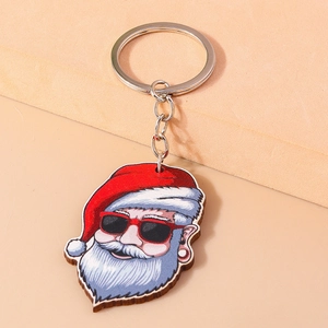 Detail view of a cool Santa keychain with red sunglasses on a simple beige backdrop