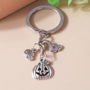 Detailed view of silver hollow Jack-o'-lantern pumpkin charms on a metal keychain ring