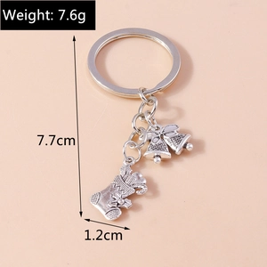 Detailed view of silver alloy Christmas bell and stocking key ring with 7.7cm total length