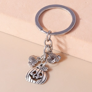 Detail of Halloween keychain featuring three vintage pumpkin pendants on a metal ring