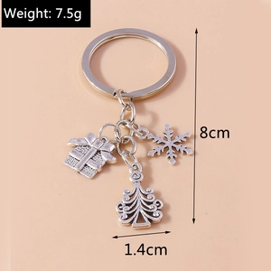 Silver Christmas keychain detail showing gift box, snowflake, and tree charms