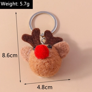 Detail view of a handmade brown wool felt reindeer keychain with red plush nose and silver ring