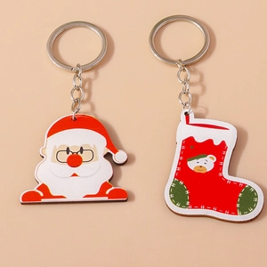 Détail de breloques de Noël en acrylique avec Père Noël et chaussette sur porte-clés argent