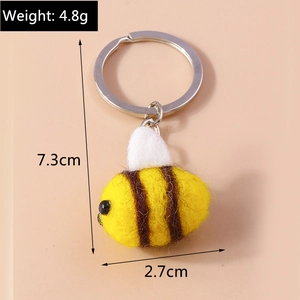 Detailed macro view showing the plush wool bee keychain texture with 7.3cm size dimensions