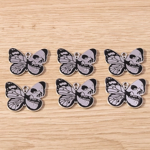 Detail view of 6 dark butterfly pendants with skull patterns for DIY jewelry making
