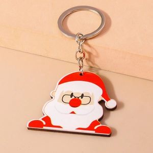 Porte-clés Père Noël mignon en acrylique avec anneau argenté sur fond chaud minimaliste
