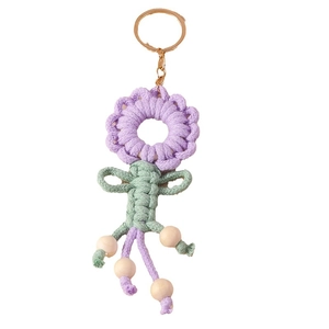 Handmade crochet sunflower keychain in purple and green with wooden beads and gold ring
