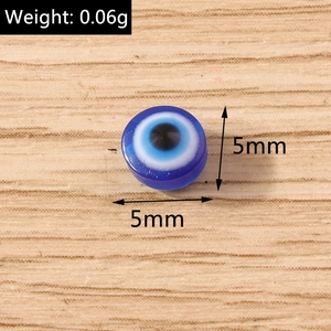 Macro shot of a 5mm blue resin evil eye bead showing weight 0.06g for DIY jewelry