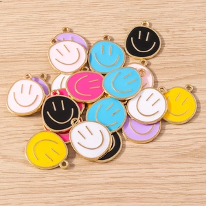 Detail view of colorful enamel smiley face charms with gold plating for jewelry DIY