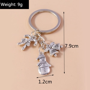 Detailed view of silver Christmas keychain with snowman, bells, and candy cane pendants