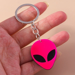 Detail view of a bright pink punk alien head keychain made of soft PVC with silver ring