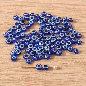 Deep blue resin evil eye nazar beads for jewelry making on light wooden background