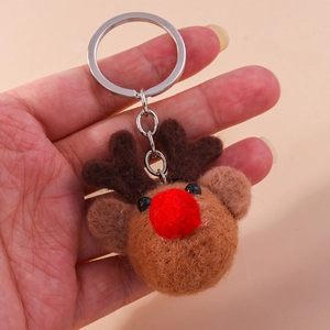 Detail of wool felt reindeer keychain with red nose and silver metal keyring