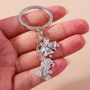 Detailed close-up of antique silver Christmas stocking keychain with bow and bells