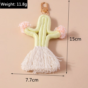 Detail view of woven cactus keychain with pink pom poms and measurements 15cm x 7.7cm