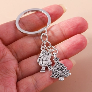 Detail of vintage silver Christmas keychain with Santa Claus and Christmas tree charms