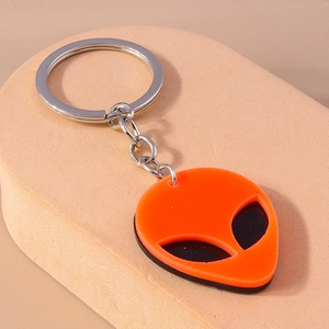 Detail of the orange and black acrylic alien keychain with a silver metal ring