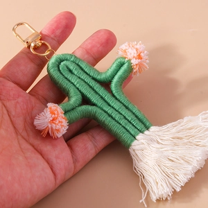Handmade woven cactus keychain with green cotton cord, orange pompoms and white tassels