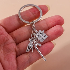 Detailed view of silver Christmas keychain featuring reindeer, gift box and candy cane pendants