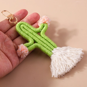 Handmade woven cactus keychain with pink pom-poms and white tassels on golden metal clasp