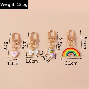 Detailed view of alloy enamel keychains featuring pink love heart and colorful unicorn