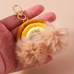 Handmade woven rainbow keychain featuring soft pom-poms and a durable gold lobster clasp