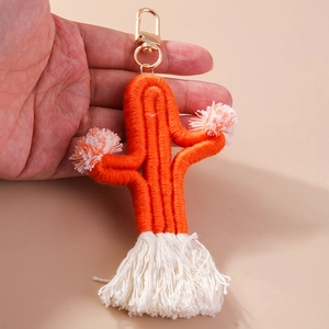 Handmade orange woven cactus keychain with plush pom poms and white cotton tassels