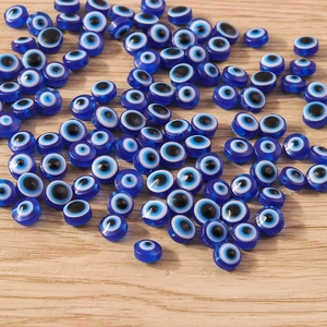 Macro shot of flat round blue resin evil eye beads for DIY jewelry making