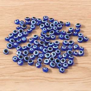 Flat round blue resin Evil Eye beads with side-drilled holes for DIY jewelry crafting