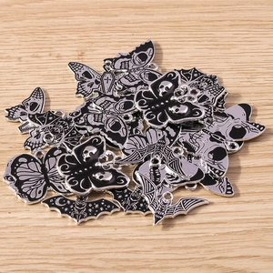 Detailed macro shot of gothic alloy charms with black enamel finish for DIY jewelry