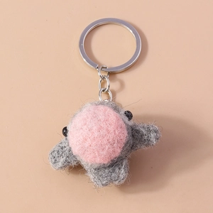 Detailed macro view of a handmade grey and pink felt animal keychain with metal ring