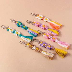 Detailed collection of handmade woven flower keychains with vibrant colorful tassels