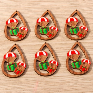 Detalle de adornos de madera en forma de gota con motivos de paracaídas y cajas de regalos