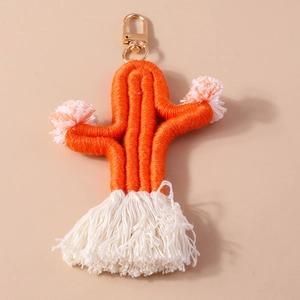 Close-up of handmade woven cactus keychain with orange cotton rope and soft tassels