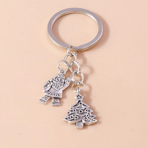 Silver alloy Christmas keychain featuring Santa Claus and Christmas tree charms in relief
