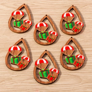 Primer plano de colgantes de madera en gota con estampado de paracaídas navideño